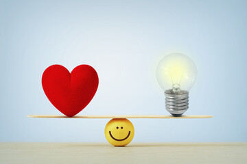 Heart and light bulb on scale - Concept of balance between heart and brain