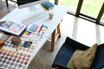 Above view of Interior designer working table with material sample and color palette