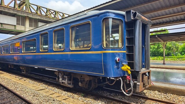 Blue and gold SRT prestige passenger car at Hua Lamphong train station in Bangkok, Thailand