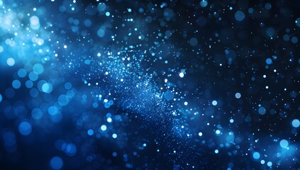Obraz premium Abstract blue glowing particles background with a bokeh effect 