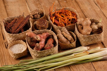 rempah-rempah, spices, ginger, lemongrass, galangal, secang wood, turmeric, tamarind, rice, palm sugar, kencur as ingredients for herbal medicine of the archipelago. Indonesian Spices. rustic table. 