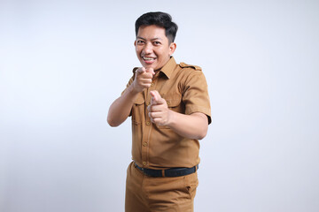 Excited male worker wearing brown uniform pointing at camera showing it's you gesture