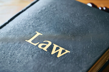 Close-up of a Law Book with Gavel in the Background