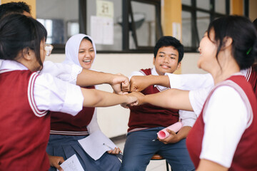 Group Of Multiethnic Asian Students Making Fist Bump Gestures