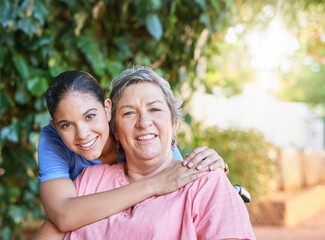 Naklejka premium Healthcare, happy and senior woman hugging nurse in portrait for assisted living. Mature, female person with disability and caregiver with wheelchair at retirement home for rehab and support