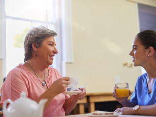 Woman, conversation and caregiver of advice in nursing home for breakfast, relax or support of medical assistance. Nurse, patient and talk for senior care by helping, trust or counselling service