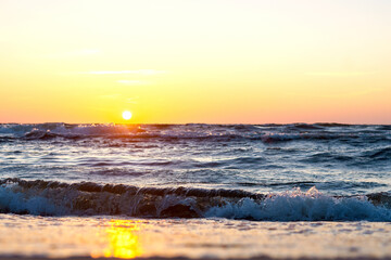 Sunset over the sea. Reflection of sunlight in the sea waves. The sky in the sunset rays. Baltic Sea.