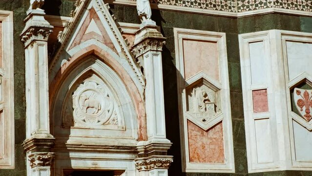 Giotto's Bell Tower (Campanile di Giotto) in Florence, Tuscany, Italy reveals all its glory under the Tuscan sun, with intricate marble patterns and sculptures