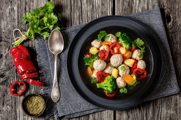 chicken meatball soup with vegetables in a bowl