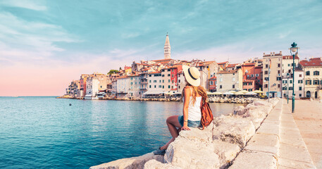 relax woman tourist sitting on rock and looking at the sea- Croatia travel destination