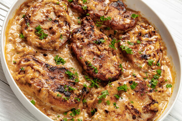 creamy smothered pork chops cooked in onion gravy