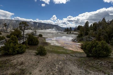 Fototapeta premium Vast body of water encircled by hills and distant trees