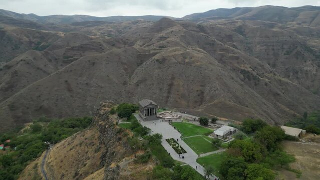 Aerial orbits rebuilt Roman Garni Temple on canyon edge in Armenia