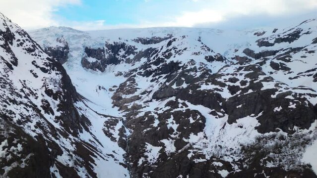 Aerial establishing shot of the dangerous glaciers within Buer Valley, Norway