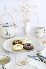 Dish with homemade donuts on a decorated tea table. Snack concept.