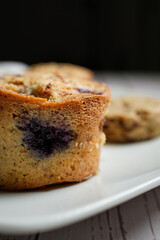 Plate with a homemade cupcake and some blurred cookies.