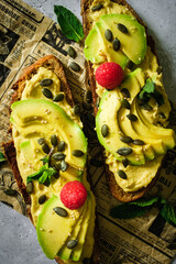 Two slices of bread with its filling on a decorative paper. Food photography.
