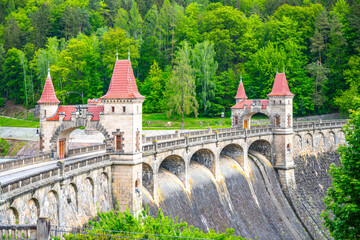 A view of the Les Kralovstvi Dam in Czechia, showcasing the intricate archway and stonework of the...