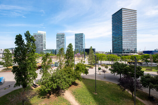 Lush greenery complements the urban setting of Plaza Europa amidst the modern buildings of Hospitalet de Llobregat, Catalonia, Spain