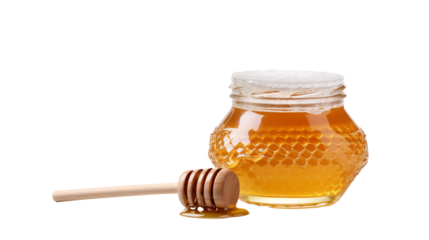 a jar of honey next to a wooden stick