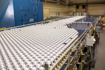 Conveyor line with the production of aluminum cans. Production of aluminum cans for drinks. Plant...