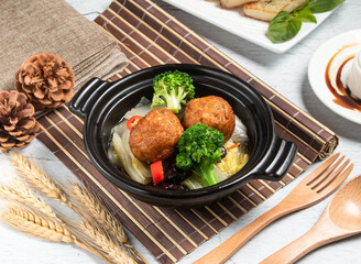 Lion's Head Dinner with wheat, spoon and fork served in broth isolated on napkin side view of taiwanese food