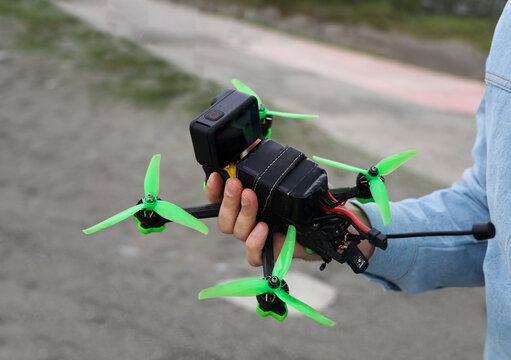  custom handmade drone, compact and perfect for beginners pilots FPV mode, in the hand of the pilot holding. quadrocopter.