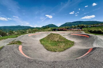 Mountain skate park with patches of grass 