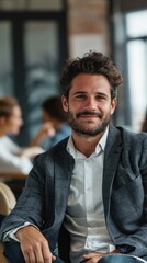 Obraz premium A man with a beard and a white shirt is sitting in a chair
