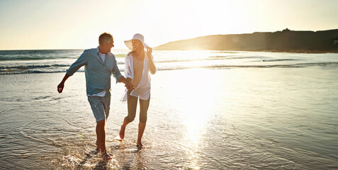 Happy couple, walking and beach for holiday on island or coast for getaway, travel and vacation in...
