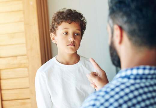 Sorry, dad and discipline child in home with learning a lesson from mistake or strict parents. Kid, thinking and father teaching son to behave or frustrated with problem or communication of conflict