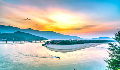 Lang Co bay in the sunset with a small fishing village completely below. This place was voted the...