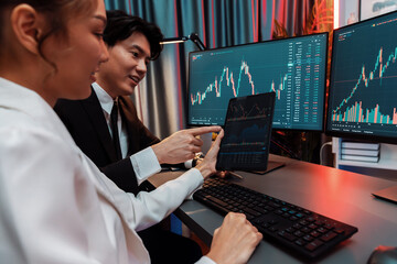Businesswoman holding tablet on dynamic stock exchange statistic online showing to partners to...