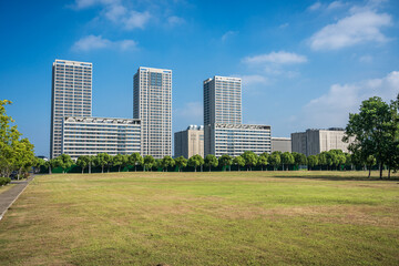 Fototapeta premium Green lawn in front of modern business building