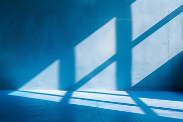 Obraz premium A blue background with the shadow of windows, light and shadows on the wall in a minimalist style