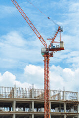 Construction site background. Hoisting cranes and new multi-storey buildings. Industrial background. Building construction site work against blue sky.