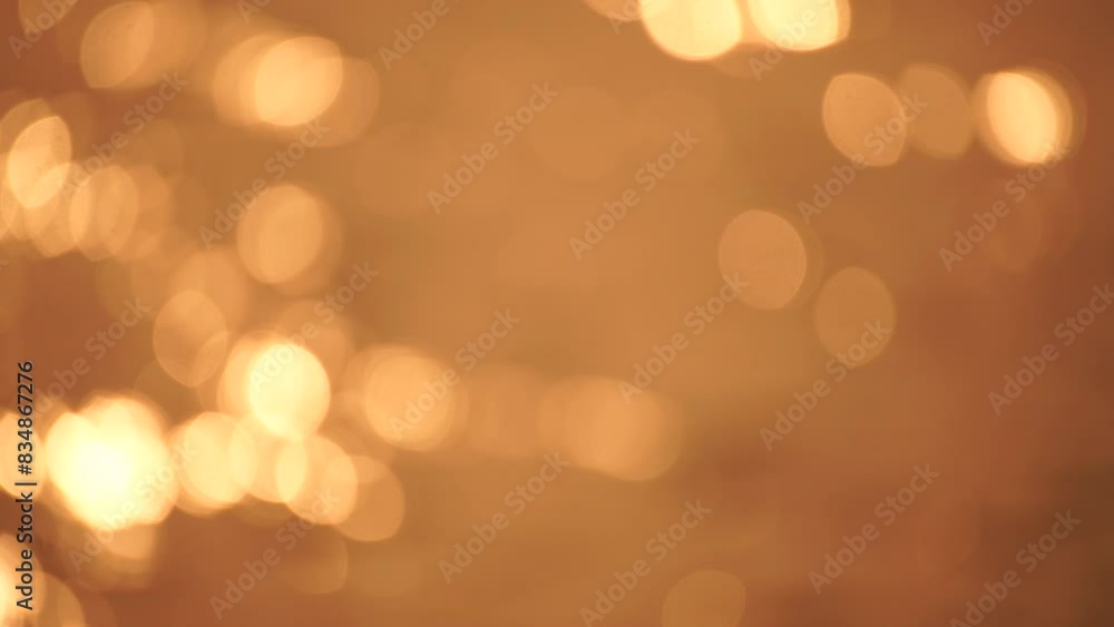 Wall mural abstract blurred video screensaver bokeh golden sea at sunset. the sun reflects and sparkles on the 