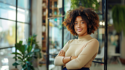 Confident young black woman with curly hair in a stylish indoor setting, plants and books in the background
