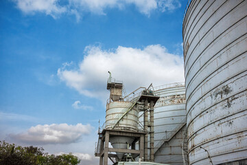 Sunlit Industrial Tanks and Metal Stairs in Power Plant
