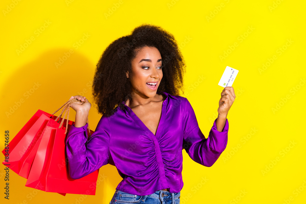 Canvas Prints Photo portrait of attractive young woman hold shopping bags credit card dressed stylish violet clothes isolated on yellow color background