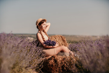 girl sitting field lavender and wearing a straw hat. She is smiling and holding a bouquet of flowers
