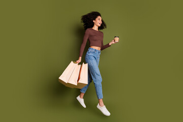 Full size photo of pretty young girl running shopping bags coffee wear trendy brown outfit isolated...