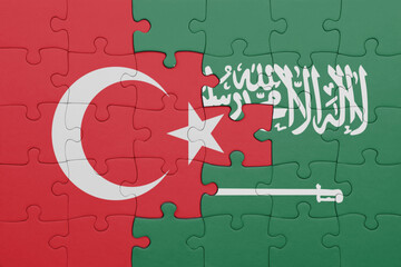 puzzle with the colourful national flag of saudi arabia and flag of turkey.