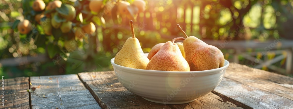 Wall mural pears in a white bowl on a wooden table, nature background. selective focus - Wall murals