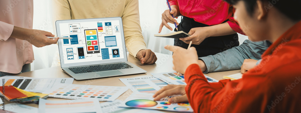 Poster cropped image of interior designer team presents color by using color swatches while laptop displaye