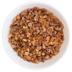 Overhead view of crushed amber (Succinit) in a white bowl, isolated on white background