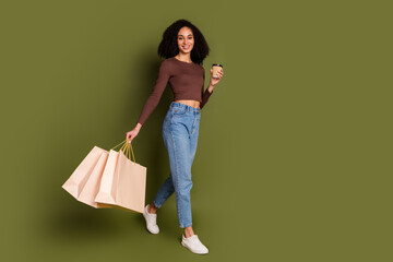 Full size photo of pretty young girl walking shopping bags coffee wear trendy brown outfit isolated...