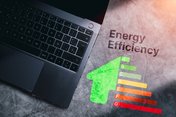 Desktop photo with Energy Efficiency rating labels on desk. Low consumption and efficient products....