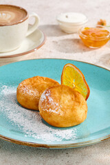 Delicious Syrniki with Citrus Garnish and Coffee on a Cozy Morning Table