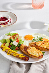 Delectable Combo Breakfast Plate with Sunny-Side-Up Egg, Cheese Toasts, Sausage, and Vegetable Salad